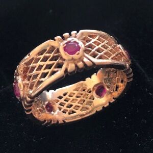 14k gold basket weave band ring size 8 with 5 small rubies set into the band..